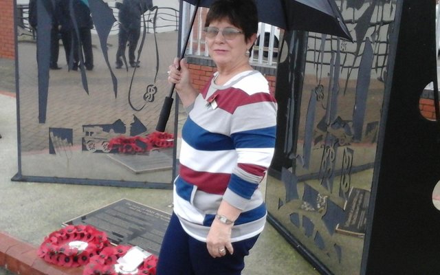 Glenda Kitley at the monument of the Birkenhead in the town, Birkenhead next to the wreathes laid by herself and the Mayor, Councilor Les Rowlands
